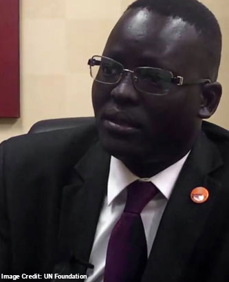 Picture of a refugee father holding her baby