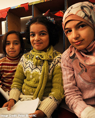 Picture of a refugee father holding her baby